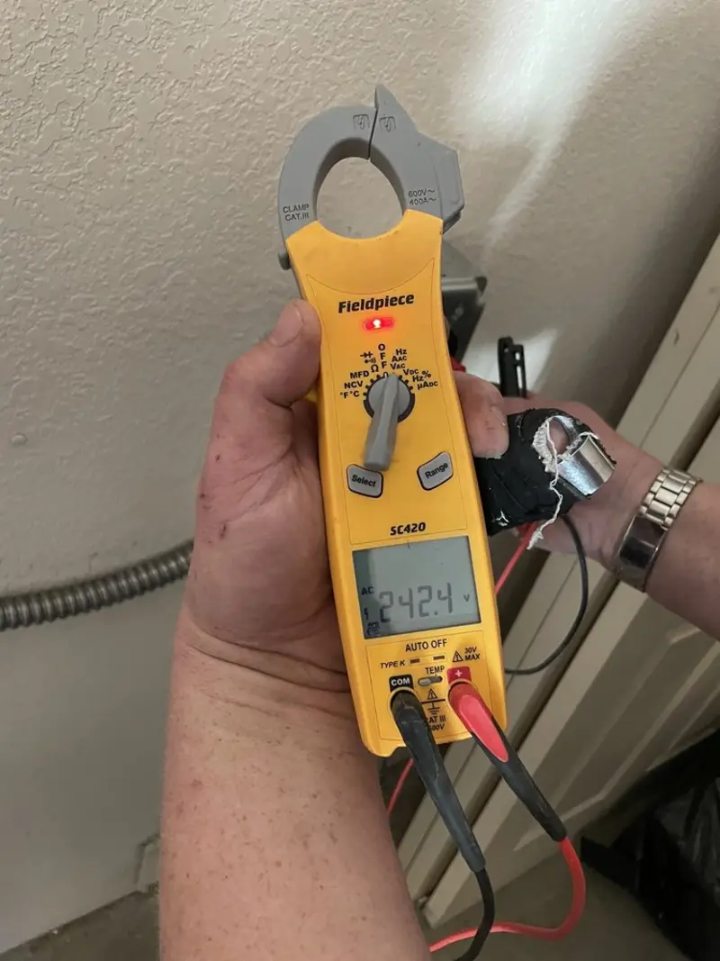 Voltage testing with clamp meter during Outlet Installation in Wyndham